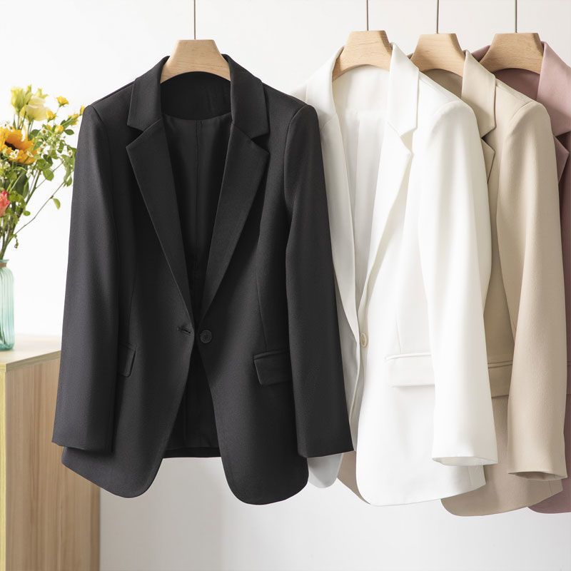 A sophisticated women's tailored jacket in a lightweight polyester blend, offering a chic silhouette.