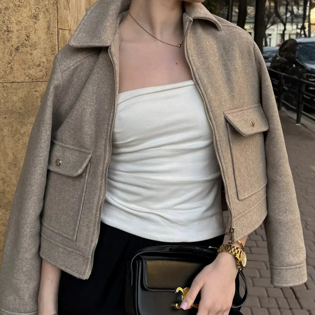 Close-up of women's wool bomber jacket with front zipper, showcasing fabric texture