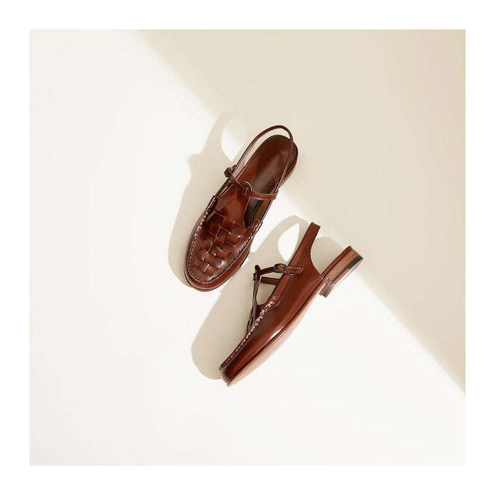 Detail shot of the adjustable slingback strap on women's woven leather sandals.