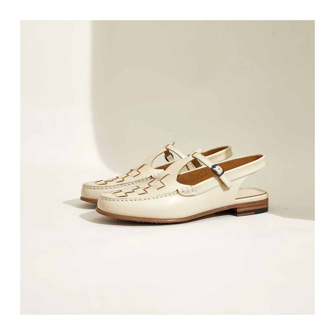 Top-down view of a pair of women's woven tan leather flat sandals with slingback closure.
