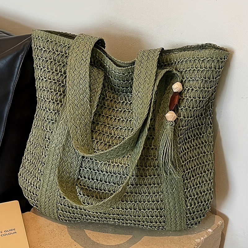 Stylish straw beach tote for women, featuring intricate woven design and decorative fringe tassels.