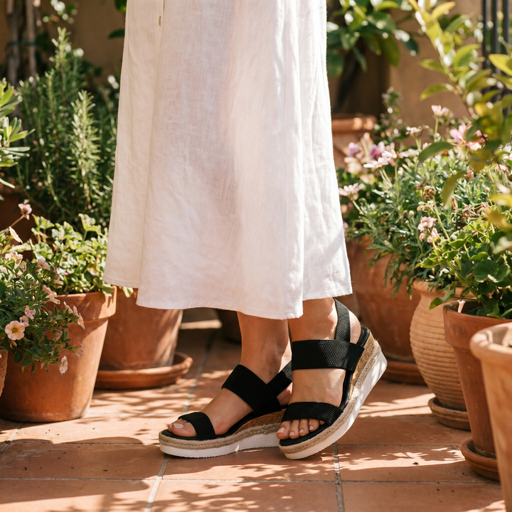 Tan women's orthopedic wedge sandals with arch support, essential comfortable footwear for summer.
