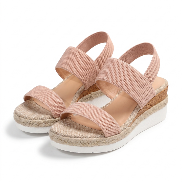 Woman walking outdoors in stylish orthopedic wedge sandals, showcasing casual summer comfort.