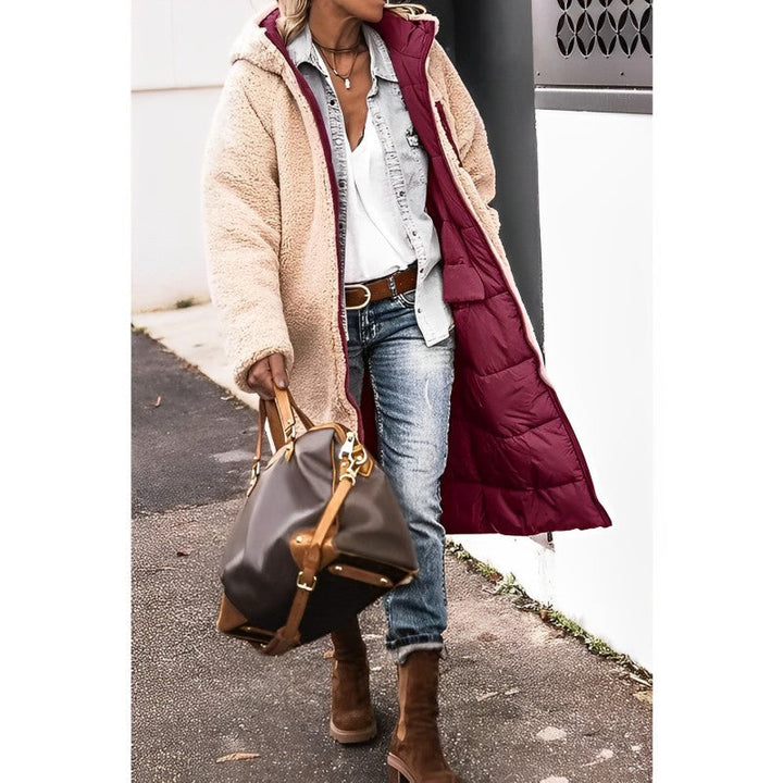 "Women's hooded longline quilted winter coat, front view; insulated, open front design with quilted texture and hood."