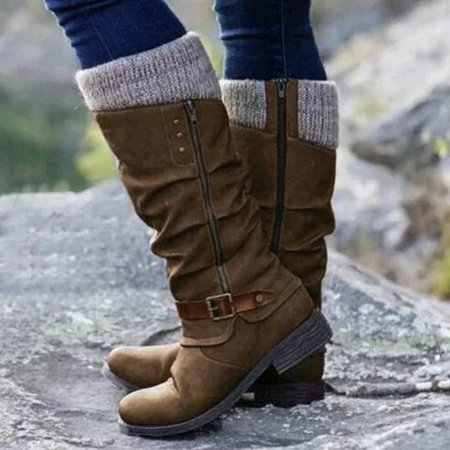 Women's knee-high boots with chic buckle, cozy knit cuff, side zipper, textured sole, and round toe in synthetic suede.