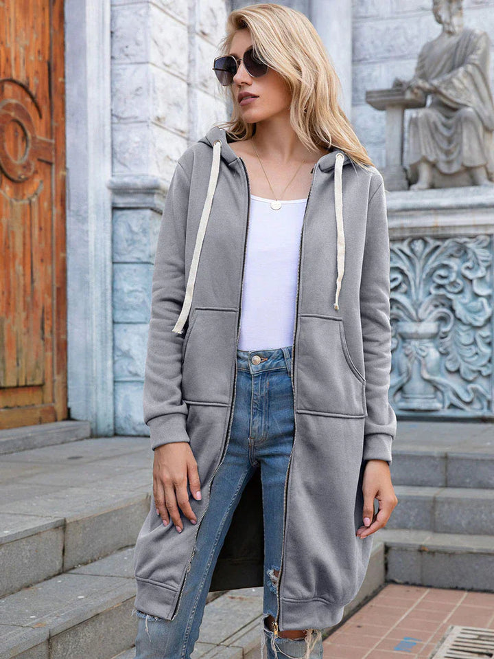 Women's longline zip hoodie with drawstring hood, midweight fabric, extended length, cozy style for cooler seasons.