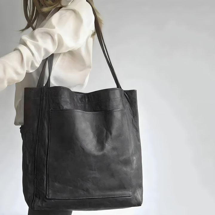 "Women's oversized leather-style shoulder tote bag with spacious interior, long straps, and elegant design."