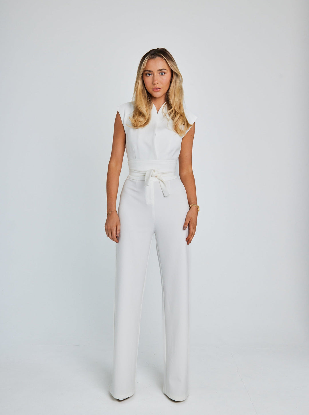 "Women's sleeveless belted jumpsuit with wide-leg, soft fabric, and detachable belt for stylish and comfortable wear."