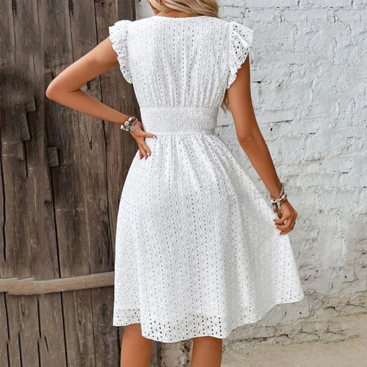 "Women's V-Neck eyelet summer dress with smocked waist, ruffled sleeves, and knee-length A-line in light fabric."