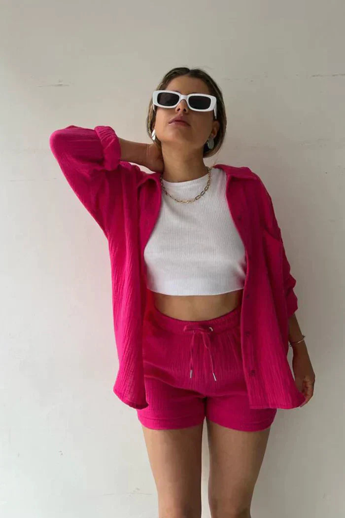 Women's vibrant summer lounge set featuring a button-up shirt and high-waist shorts in a bold, casual style.