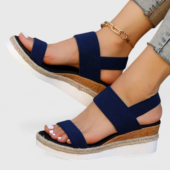 Back view of women's orthopedic wedge sandals, highlighting the secure ankle strap & stable wedge.